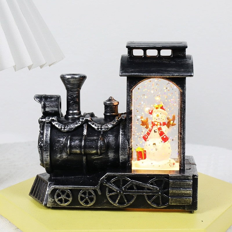 Decoratiune de Craciun tip Locomotiva, Glob de Cristal cu Fulgi de Zapada, Model Om de Zapada, Iluminare LED, 11.5 x 12.5 x 6 cm, Carcasa Vintage Bronze, Transparent
