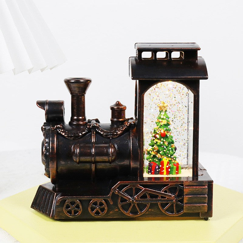 Decoratiune de Craciun tip Locomotiva, Glob de Cristal cu Fulgi de Zapada, Model Pom de Craciun, Iluminare LED, 11.5 x 12.5 x 6 cm, Carcasa Vintage Bronze, Transparent