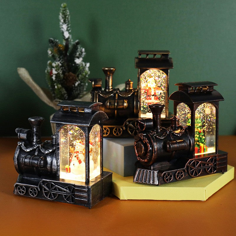 Decoratiune de Craciun tip Locomotiva, Glob de Cristal cu Fulgi de Zapada, Model Pom de Craciun, Iluminare LED, 11.5 x 12.5 x 6 cm, Carcasa Vintage Bronze, Transparent